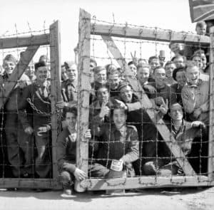 POWs at Stalag 11B at Fallingbostel in Germany welcome their liberators, 16 April 1945.