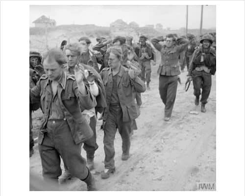 German prisoners being marched along Queen beach, Sword area, 6 June 1944.IWM (B 5079)